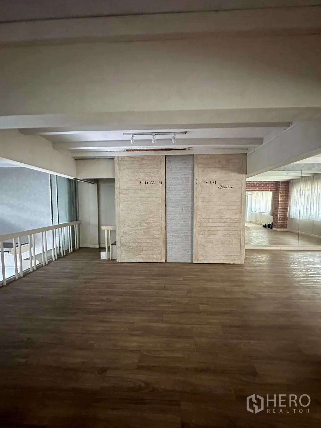 Retail Space for rent in Watthana, Bangkok - Mezzanine landing with feature wall panels and wood floors overlooking lobby