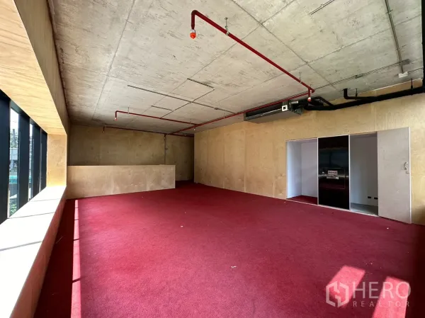 Retail Space for rent in Watthana, Bangkok - Spacious mezzanine with red flooring, sliding door and exposed ceiling services.