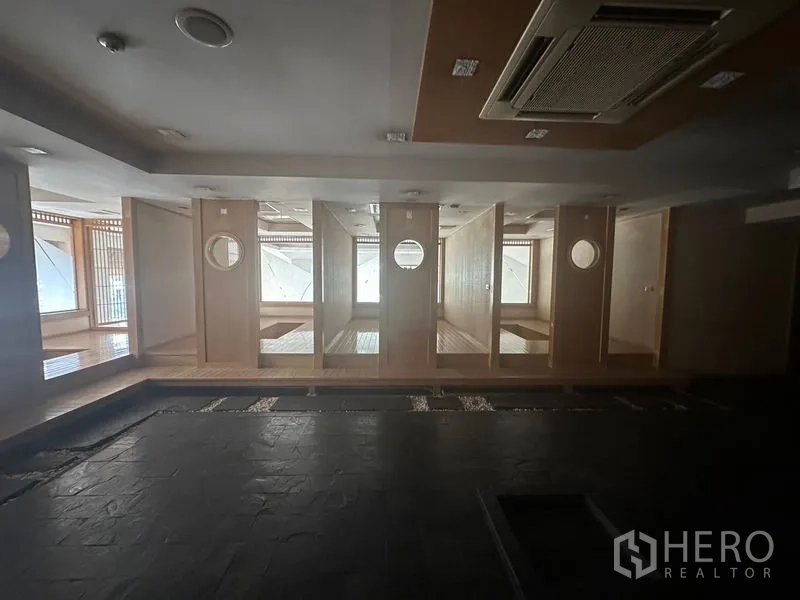 Retail Space for rent in Bang Rak, Bangkok - Row of wooden private booths with round windows and built-in seating.