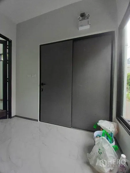 Retail Space for rent in Khlong Toei, Bangkok - Interior view of gray sliding doors and window in the retail unit.