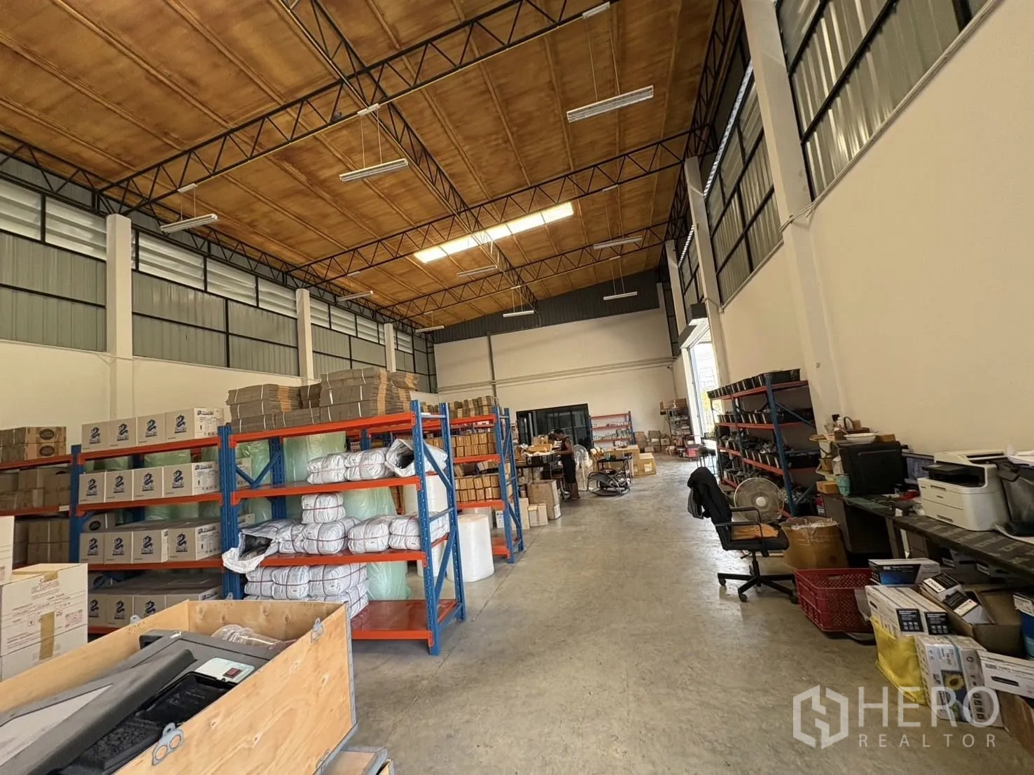Factory for rent or sale in Bang Len, Nakhon Pathom - Warehouse aisle with shelving units, fluorescent lighting, and polished concrete floor.