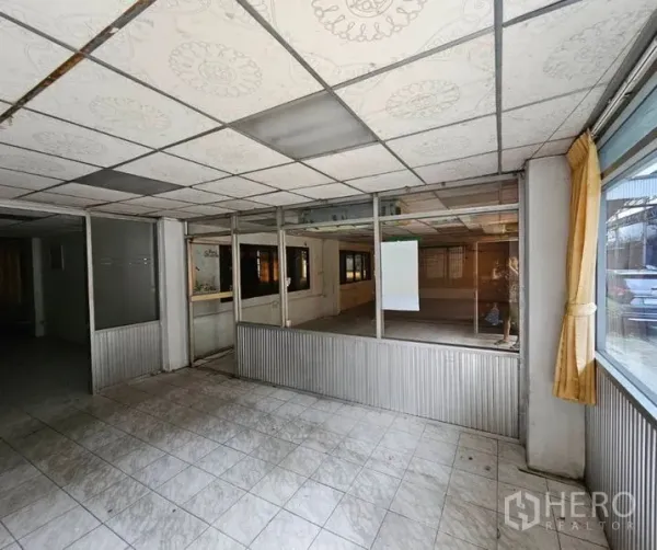Factory for rent in Bang Kho Laem, Bangkok - Glass-partitioned office area with tiled floor and suspended ceiling.