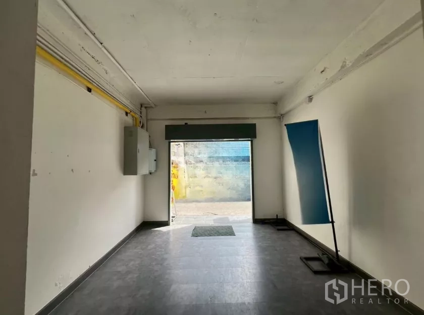 Retail Space for rent in Pathum Wan, Bangkok - Ground-floor retail unit with tiled floor, wide storefront opening to the lane, and visible electrical panels.