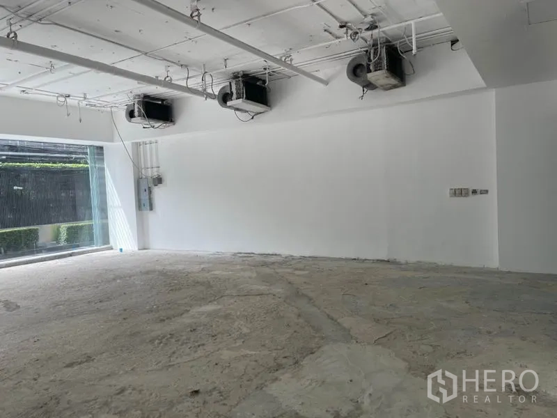 Retail Space for rent in Watthana, Bangkok - Close-up of white wall, ceiling-mounted air-conditioning and electrical panel ready for fit-out.