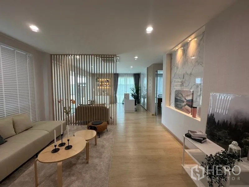 Warehouse for sale in Pathum Thani - Lounge area with sofas, wood accents and decorative wall within the office building.