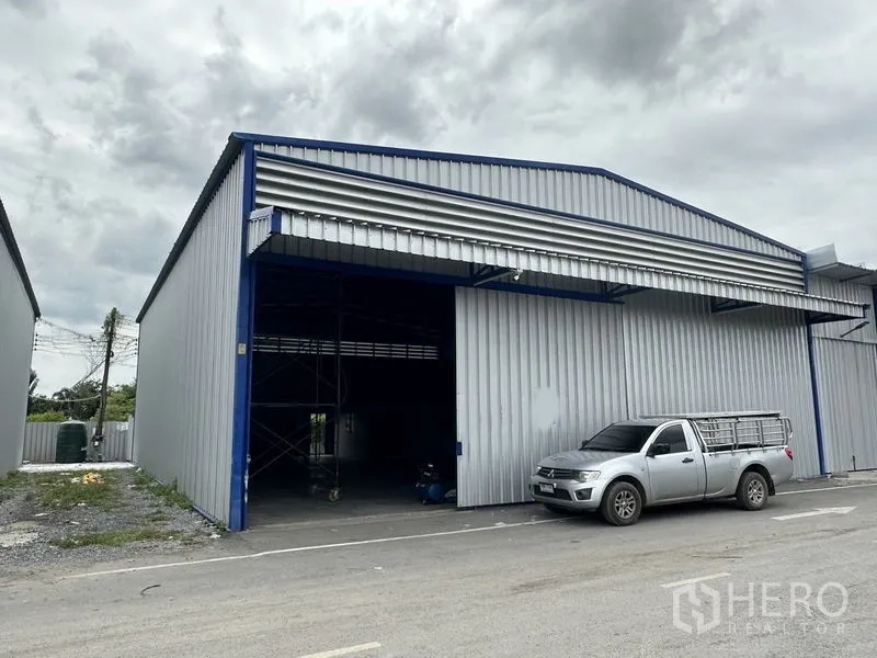 Warehouse for rent in Khlong Luang, Pathum Thani - Front elevation of the warehouse showing a large 4x4 m loading door and covered bay.