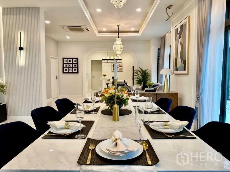 Detached House for rent in Bang Phli, Samut Prakan - Close-up of elegant dining table setting with chandelier above.