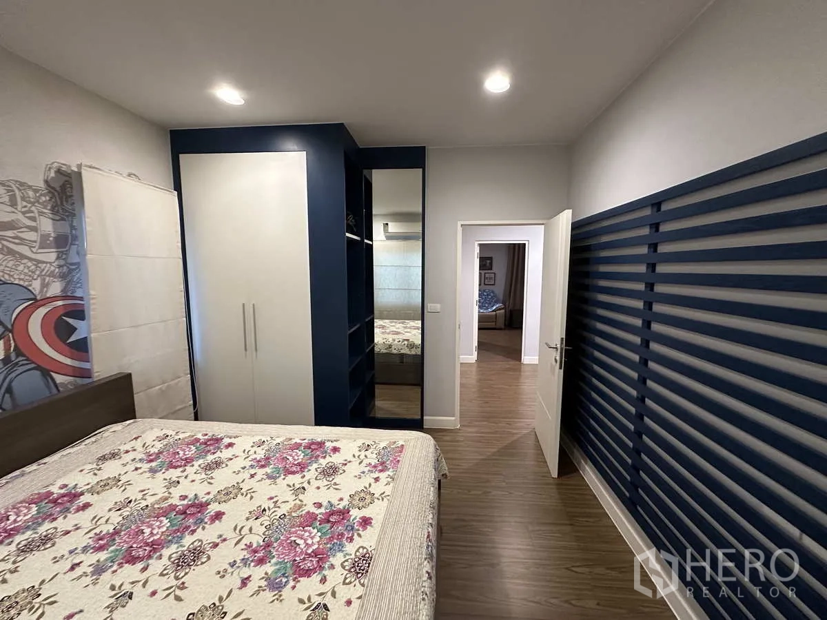 Detached House for rent or sale in Lam Luk Ka, Pathum Thani - Secondary bedroom with built‑in wardrobe and blue accent wall detailing.