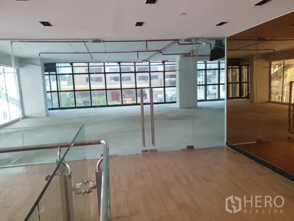 Retail Space for rent in Watthana, Bangkok - Second-floor retail unit with glass double doors and full-height windows providing abundant natural light.