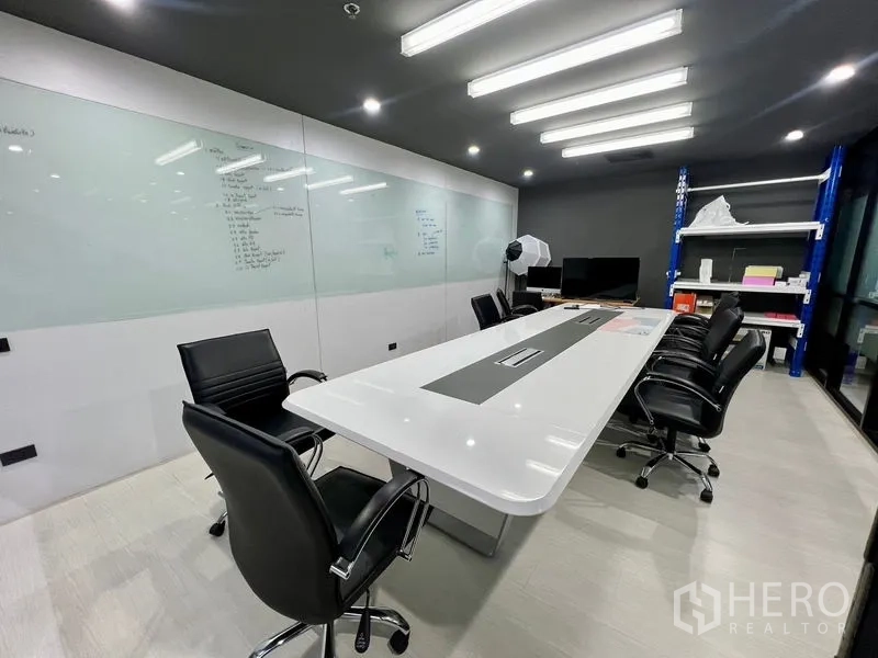 Office Space for rent in Watthana, Bangkok - Conference room featuring long white table, ergonomic chairs and full whiteboard wall.