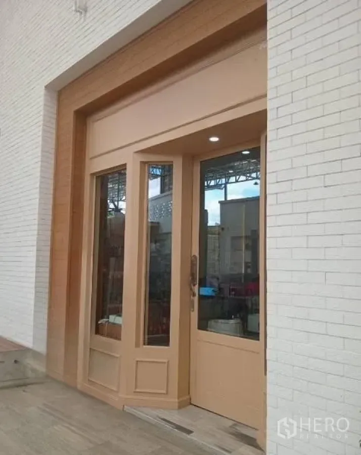 Retail Space for rent in Khlong Toei, Bangkok - Street‑facing shopfront with tall wood‑framed glass door set in a white brick facade.