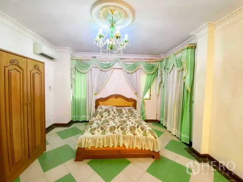 Detached House for rent or sale in Bang Khen, Bangkok - Bright bedroom with green drapes, patterned tile floor, and chandelier.