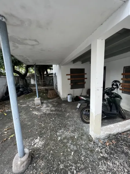Detached House for rent in Sathon, Bangkok - Covered carport and patio area with concrete floor and support columns.