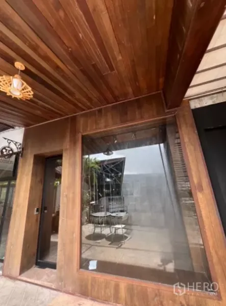 Retail Space for rent - Wood-clad shopfront with picture window and timber ceiling under canopy.