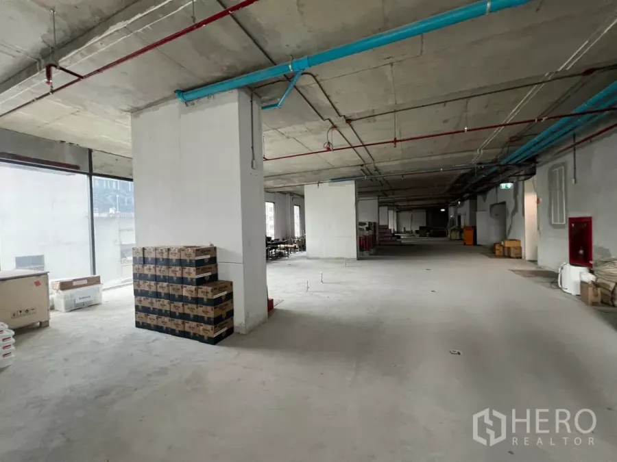 Office Space for rent in Khlong Toei, Bangkok - Unfurnished open-plan office floor with exposed ceiling pipes, structural columns and large windows in Khlong Toei.