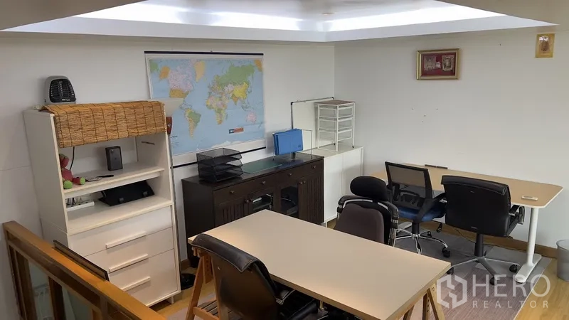 Townhouse for rent or sale in Khlong Toei, Bangkok - Mezzanine home office with desks, shelves and soft ceiling lighting.