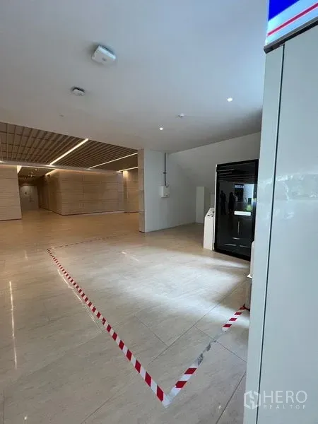 Retail Space for rent - Bright building lobby with a designated retail kiosk area beside a glass display cabinet.