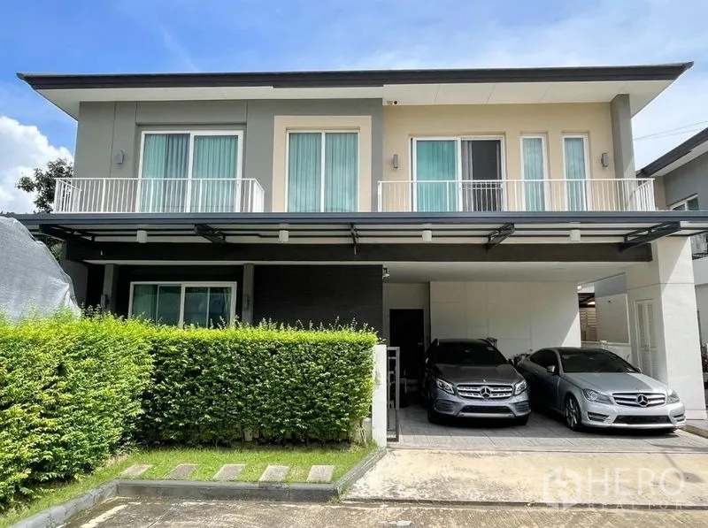 Detached House for rent or sale in Bang Khen, Bangkok - Street-facing exterior of a contemporary detached house with balconies and double carport.