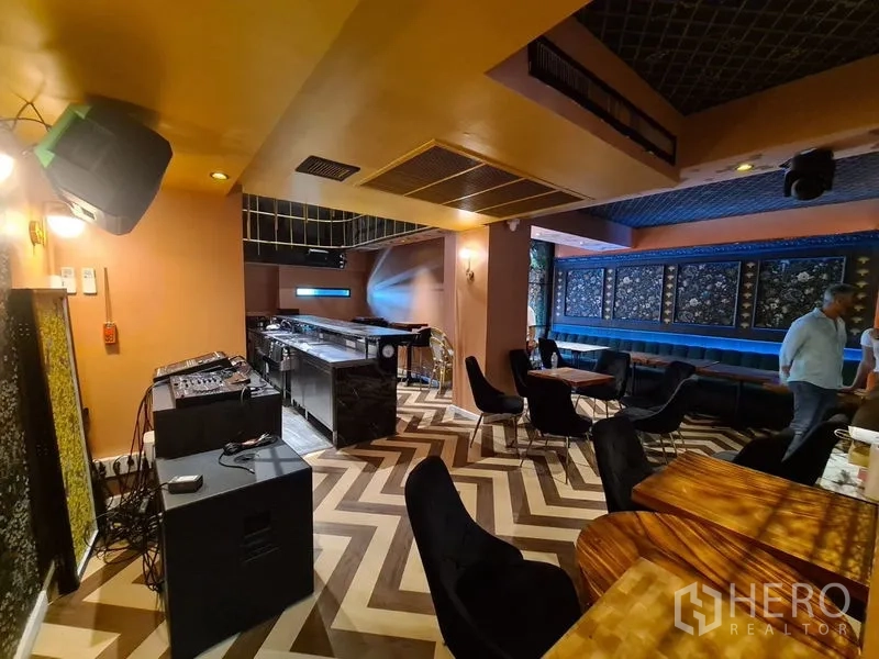 Retail Space for rent in Bang Rak, Bangkok - Open bar lounge with chevron floor, long banquette seating, tables and service counter.