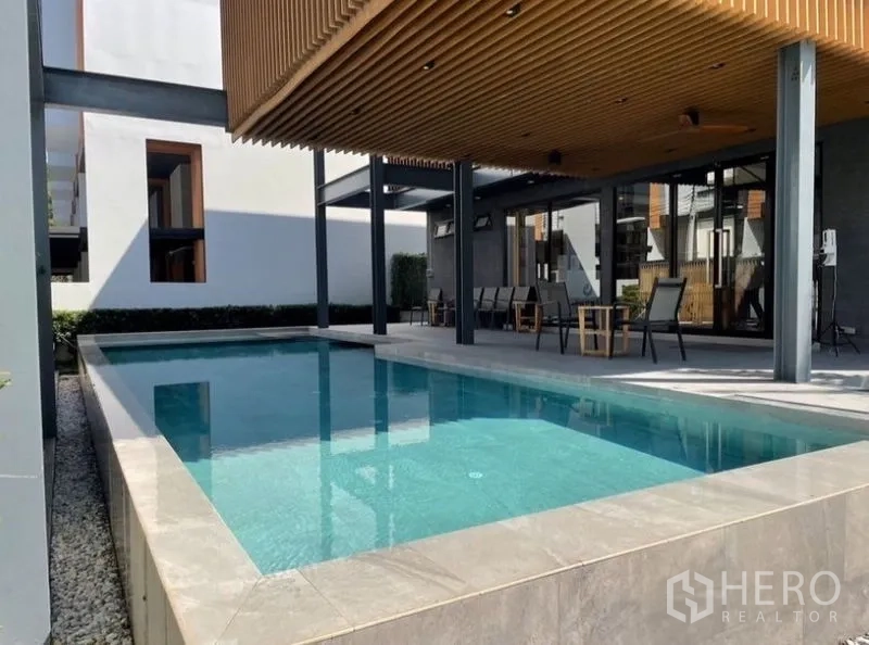 Townhouse for rent in Suan Luang, Bangkok - Communal swimming pool with shaded pavilion and seating area.