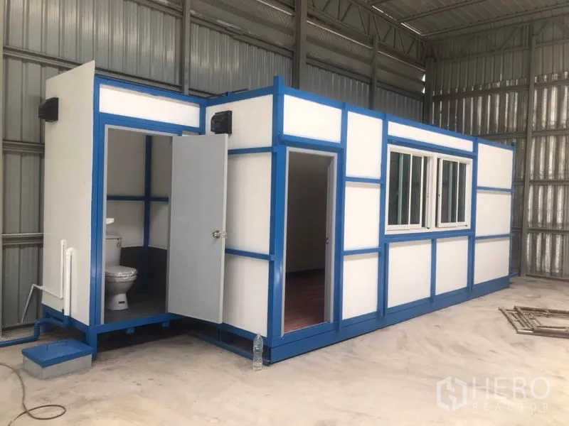 Warehouse for rent in Lat Phrao, Bangkok - Modular office cabin with window, doors and an attached restroom installed inside the warehouse.