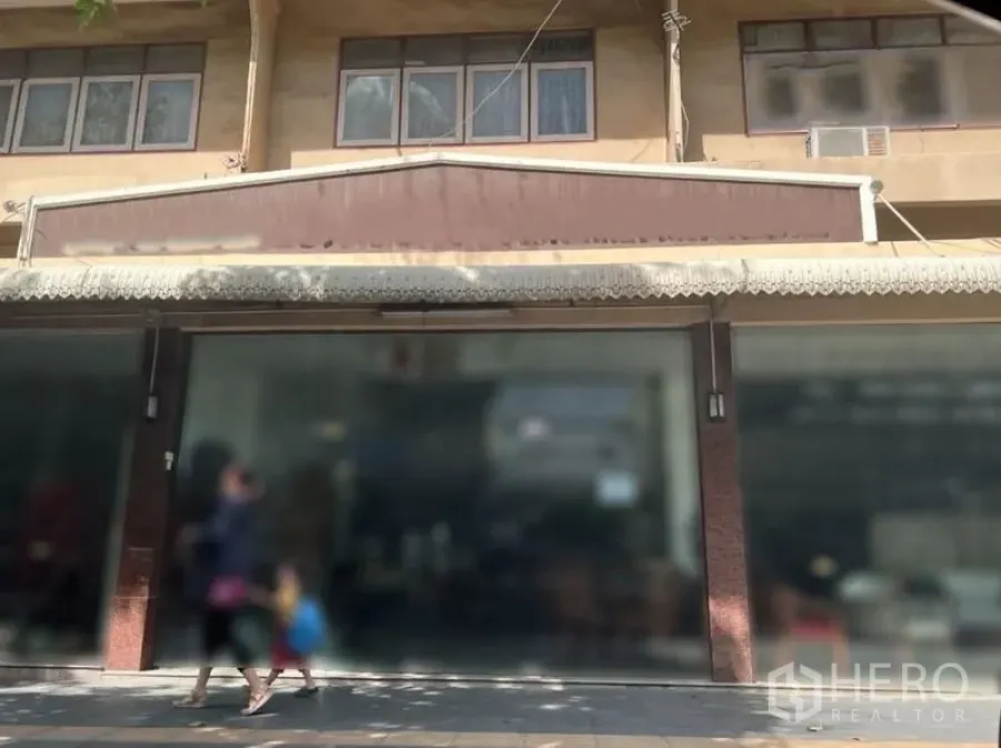 Retail Space for rent in Watthana, Bangkok - Central retail frontage with large signage panel, glass display windows and a shaded pedestrian pavement.