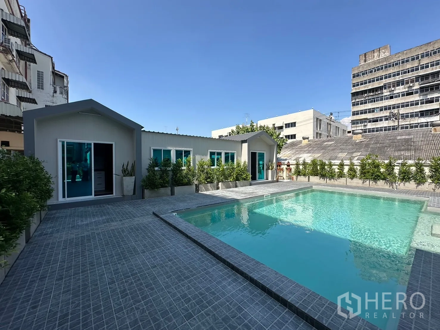 Home Office for rent in Suan Luang, Bangkok - Pool view of long pavilion building and greenery.