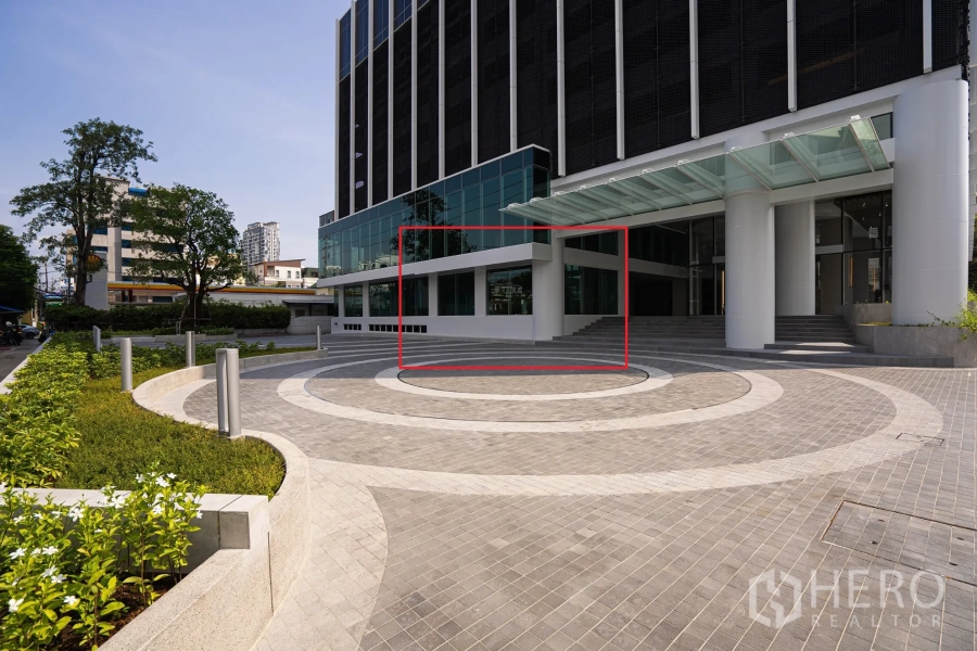 Retail Space for rent in Sathon, Bangkok - Modern tower entrance with circular plaza and a highlighted ground-floor retail frontage.