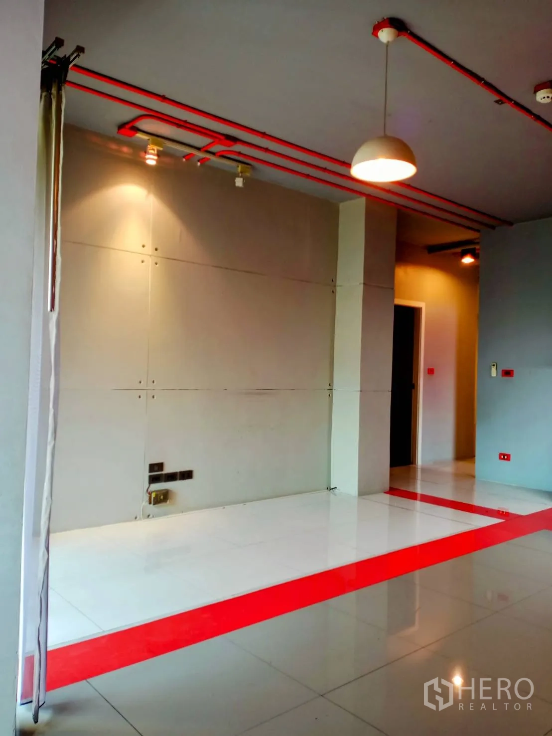 Office Space for rent in Khlong Toei, Bangkok - Minimal office area with pendant light, exposed ceiling pipes and recessed outlets.