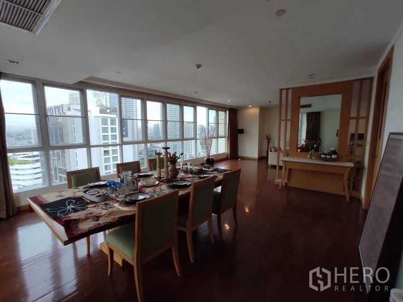 Condominium for rent in Khlong Toei, Bangkok - Long dining room with panoramic windows and Bangkok skyline views.