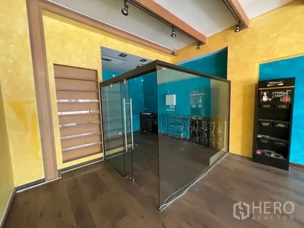 Retail Space for rent in Watthana, Bangkok - Central glass-enclosed room suitable for cashier or consultation, with shelving and product display rack.