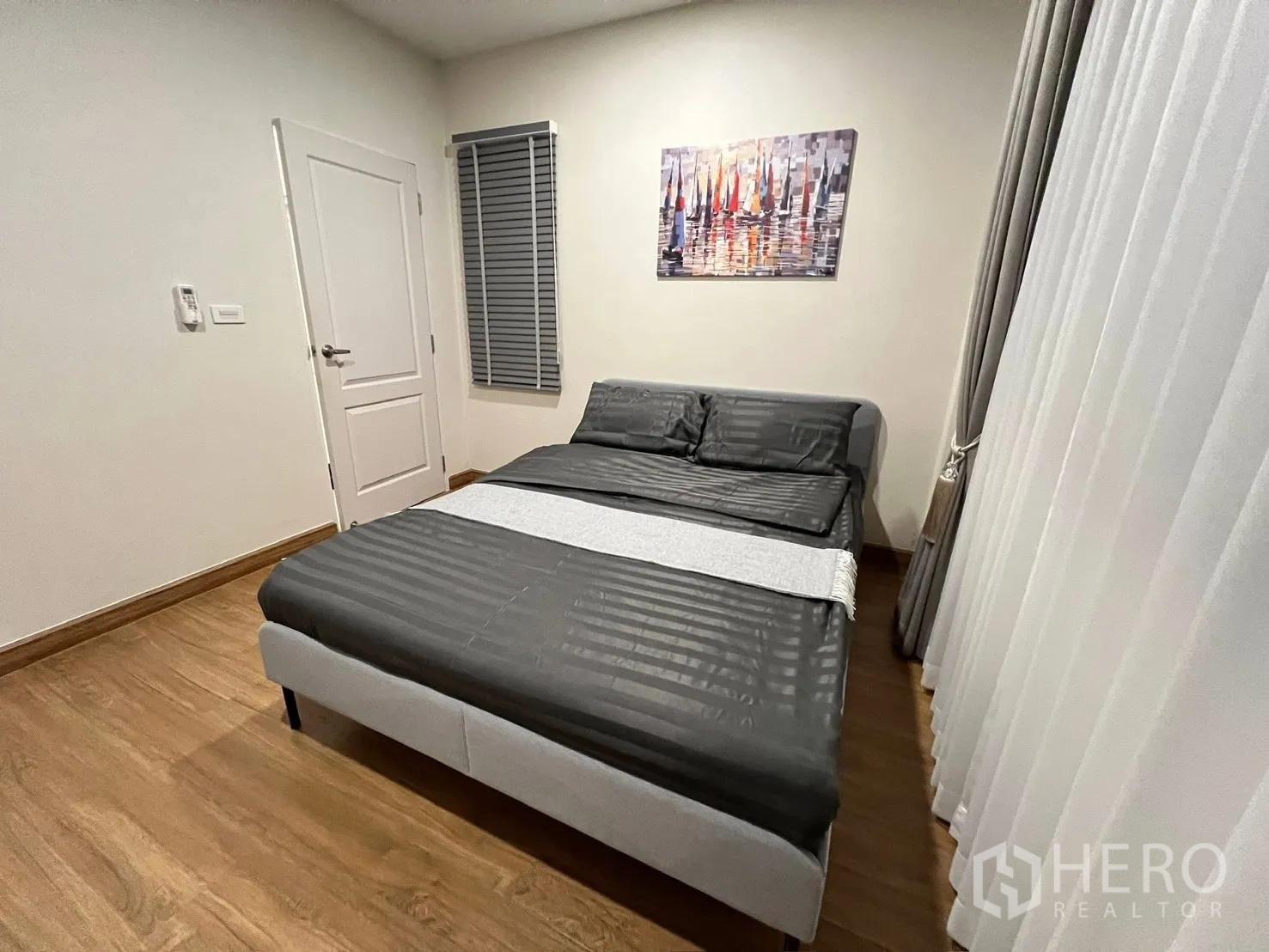 Detached House for rent in Prawet, Bangkok - Guest bedroom showing bed, door, blinds and flowing drapes.
