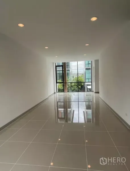 Home Office for rent in Bueng Kum, Bangkok - Bright upper-floor workspace with a large window overlooking the street.