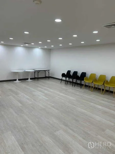 Office Space for rent in Khlong Toei, Bangkok - Meeting or training area with recessed ceiling lights, laminate floor and rows of chairs.