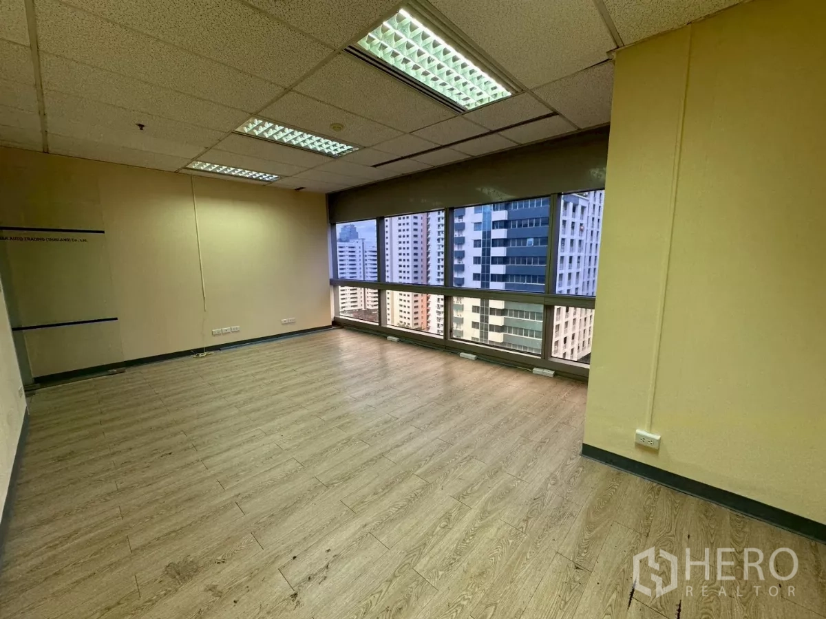 Office Space for rent in Watthana, Bangkok - Corner office with floor‑to‑ceiling windows and Bangkok skyline views.