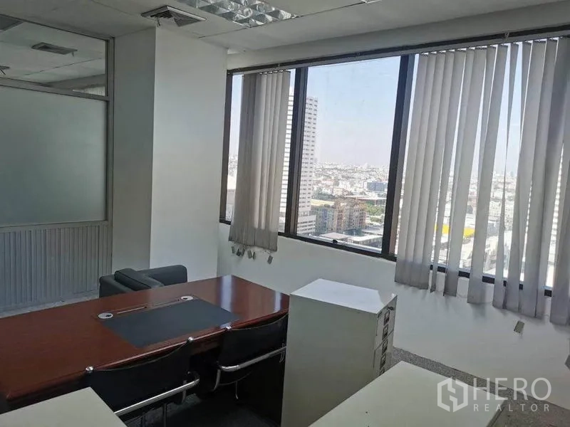 Office Space for rent in Bang Na, Bangkok - Private office with meeting table and panoramic Bangkok city view through large windows and blinds.
