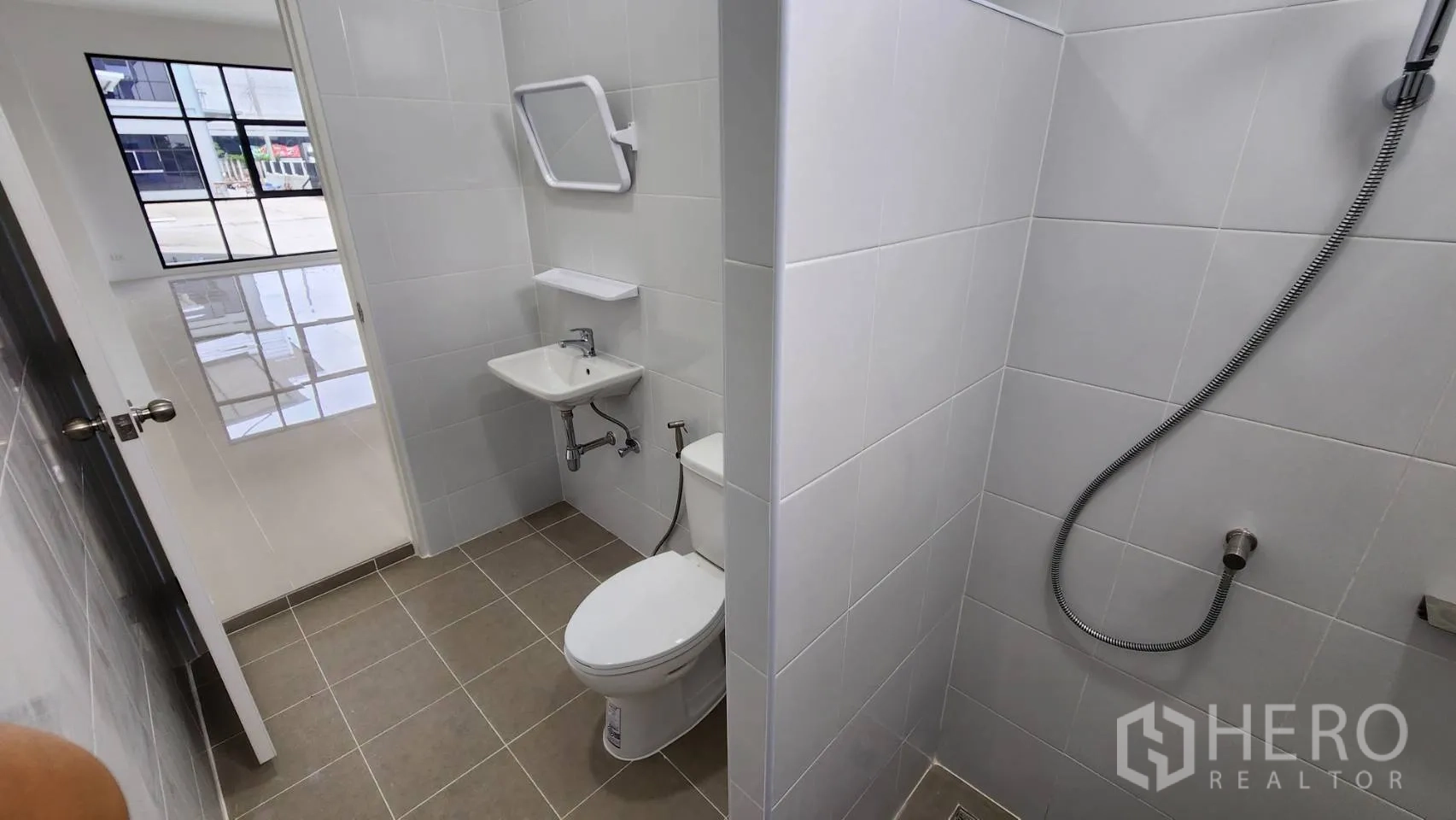 Factory for rent or sale in Bang Bo, Samut Prakan - Second restroom view showing toilet, sink and partitioned shower zone.