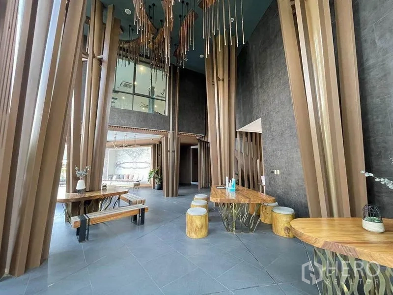 Detached House for sale in Pak Kret, Nonthaburi - Modern clubhouse lobby with double-height ceiling and sculptural wooden columns.