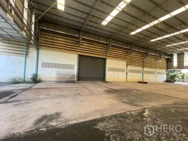 Warehouse for rent or sale in Bang Bon, Bangkok - Row of roller shutter loading doors inside the warehouse.