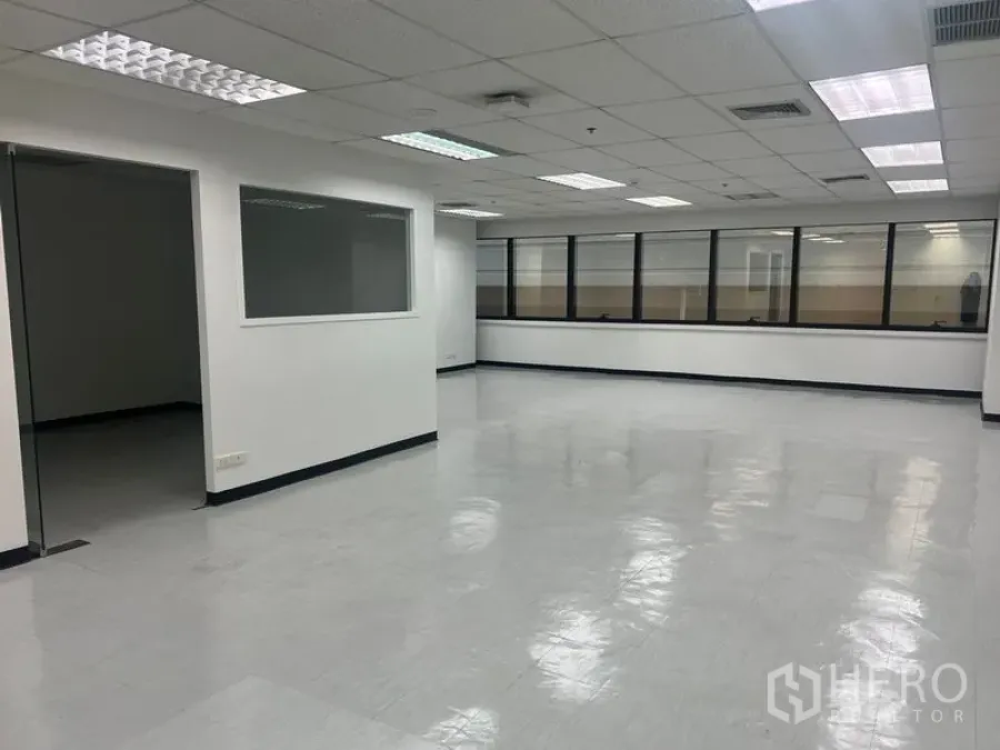 Office Space for rent in Watthana, Bangkok - Open-plan office with internal glass partition and multiple ceiling light panels.