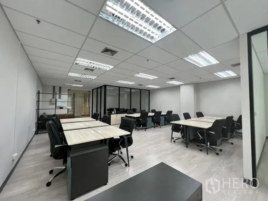 办公空间 出租在Sathon, Bangkok - 宽阔办公楼层全景，顶棚灯光、玻璃隔间与多组工位。