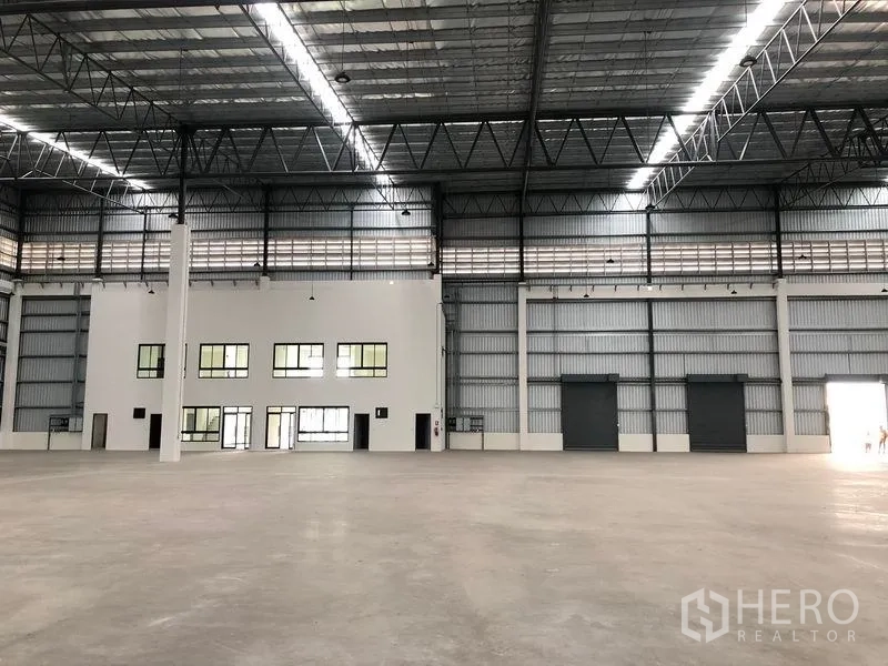 工厂 出租在Samut Prakan - 大跨度仓厂内部，多个卷帘门与内置办公室，保温高屋顶。