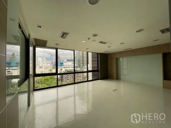 Office Space for rent in Bang Rak, Bangkok - Bright corner office with large windows and Bangkok skyline views.