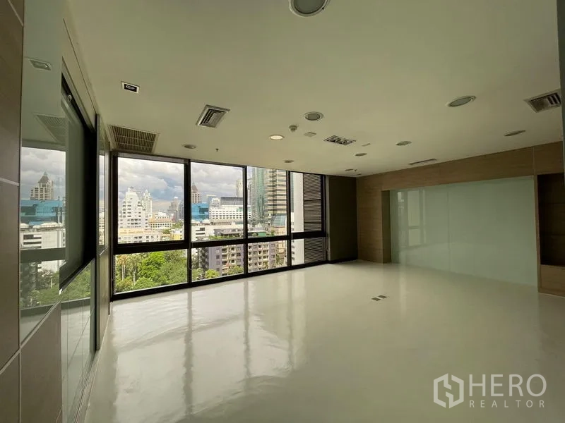 Office Space for rent in Bang Rak, Bangkok - Bright corner office with large windows and Bangkok skyline views.