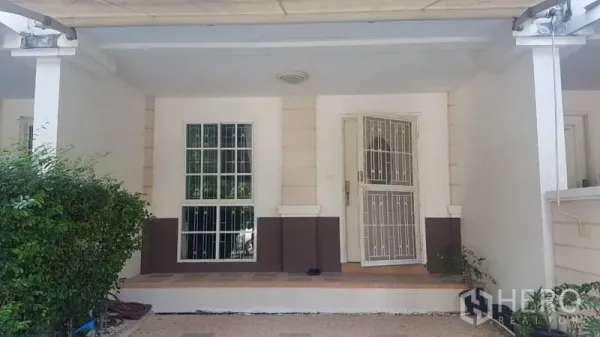 联排别墅 出租在Bang Kapi, Bangkok - 带顶前门廊与车位，白色防盗门。