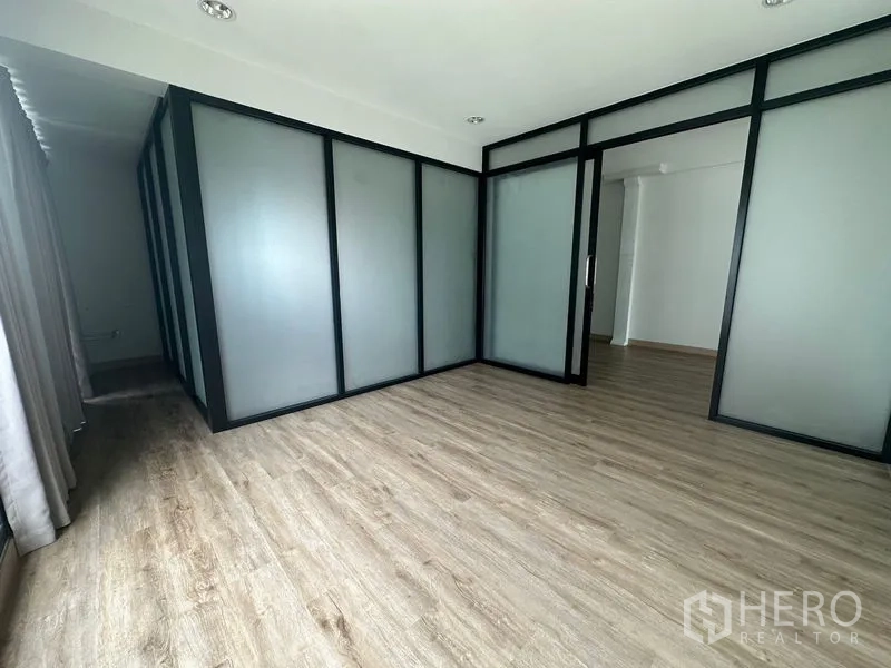 Home Office for rent in Suan Luang, Bangkok - Partitioned meeting room with frosted glass and wood flooring.