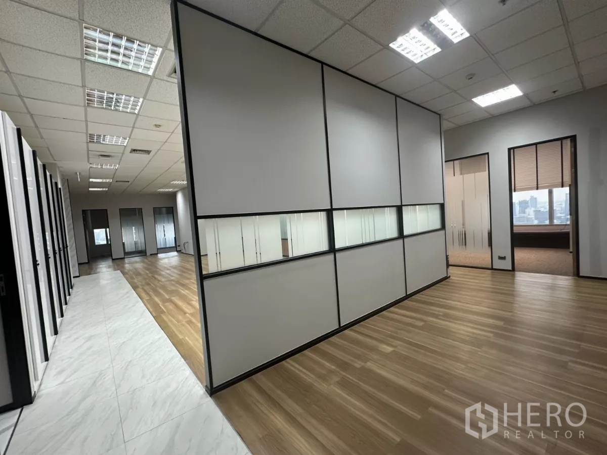 Office Space for rent in Watthana, Bangkok - Open-plan workspace with wood and marble flooring and modern partition walls.