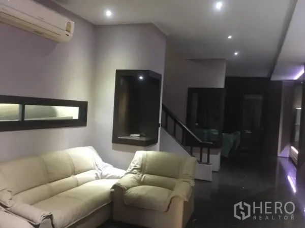 Home Office for rent in Suan Luang, Bangkok - Lounge area with sofa, staircase and recessed ceiling lights.