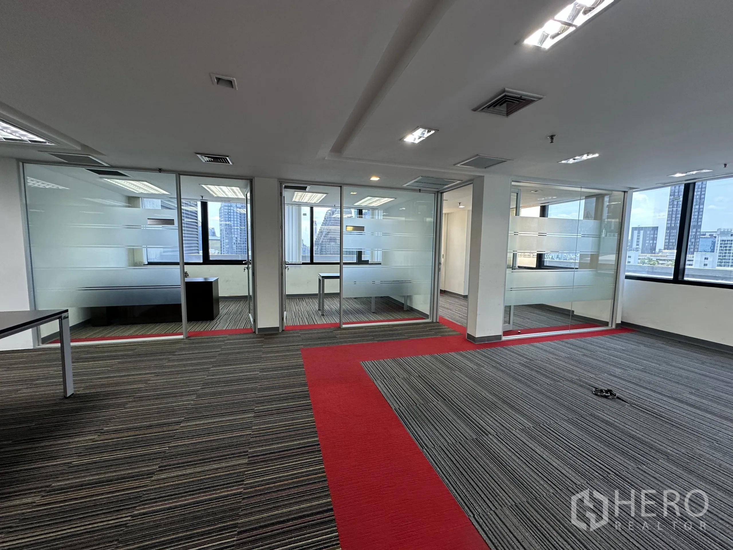 Office Space for rent in Watthana, Bangkok - Private manager offices with frosted glass walls and windows overlooking Bangkok.