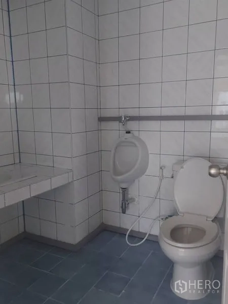 Office Space for rent in Pathum Wan, Bangkok - Tiled office restroom with sink, urinal and toilet.
